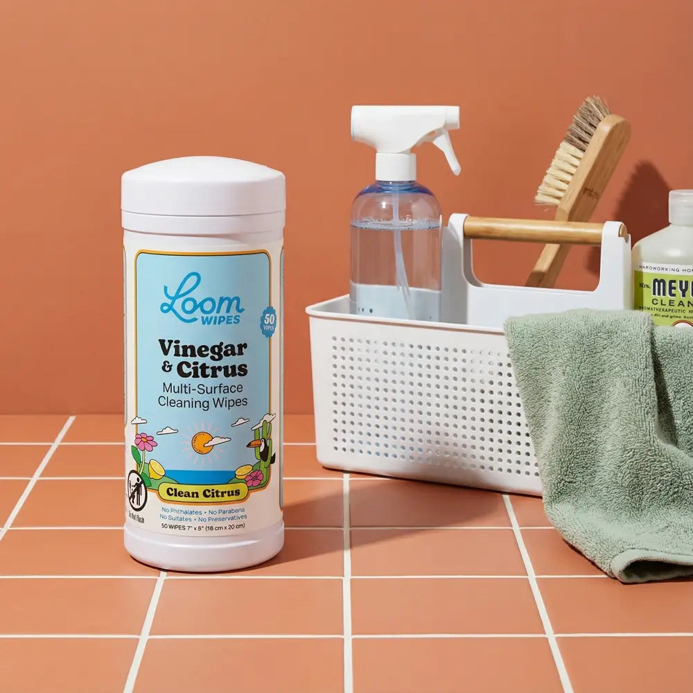 Vinegar and citrus Loom Wipes canister next to cleaning supplies